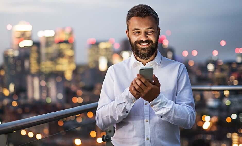 smiling man looking at his phone