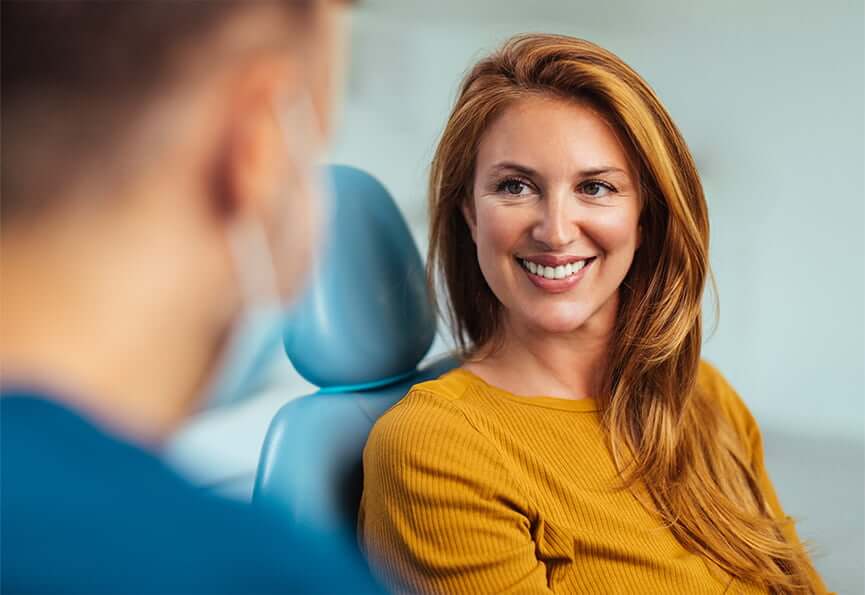 smiling woman sitting in a dental chair