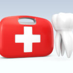 A white tooth floats next to a red and white first aid kit