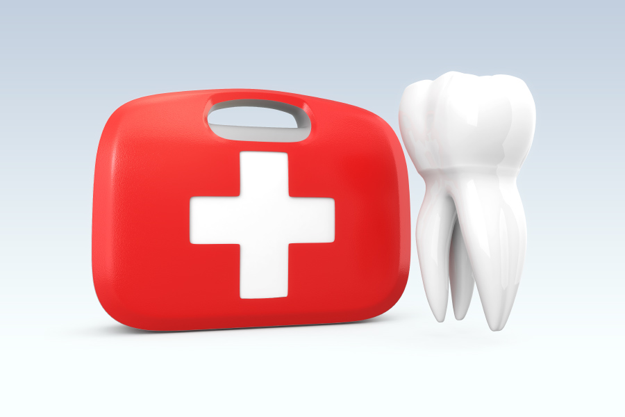A white tooth floats next to a red and white first aid kit
